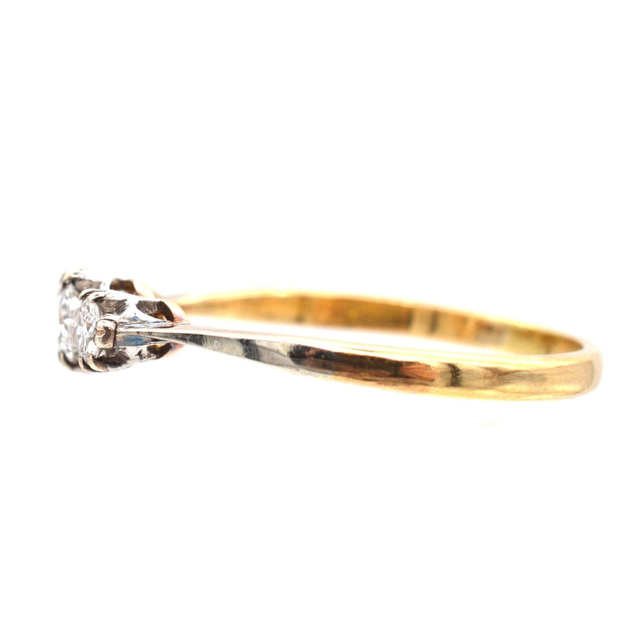Art Deco 18ct gold and platinum three stone diamond ring from the 1930s, featuring bright white diamonds.