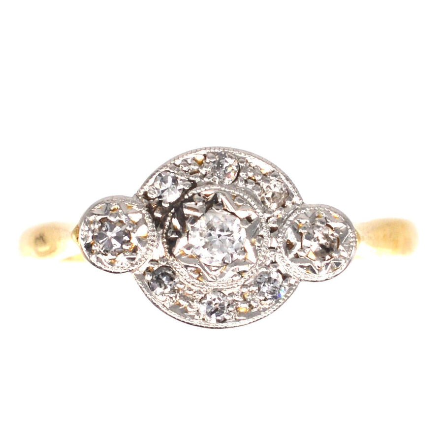 Art Deco 18ct gold and platinum three stone diamond ring with star halo design for engagement.