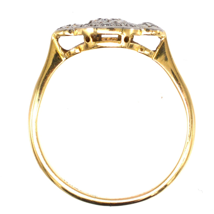 Back view of an Art Deco 18ct gold ring featuring intricate detailing and a three-stone diamond star halo design.