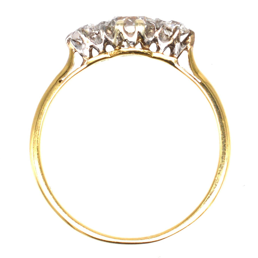 Art Deco 18ct gold three stone diamond ring featuring a central transitional cut diamond, elegant and timeless design.