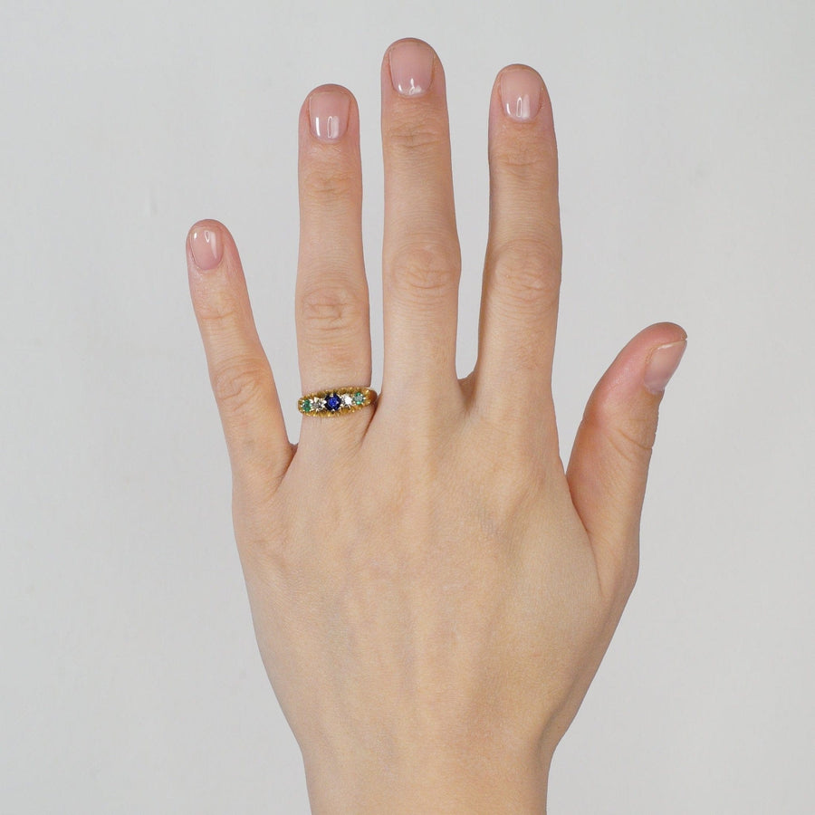 Art Deco 18ct gold 'Tutti Frutti' ring with sapphire, emerald, and diamond gemstones, showcased on a hand.