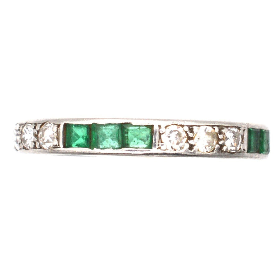Art Deco 18ct white gold eternity ring with emeralds and diamonds, a perfect symbol of enduring love.