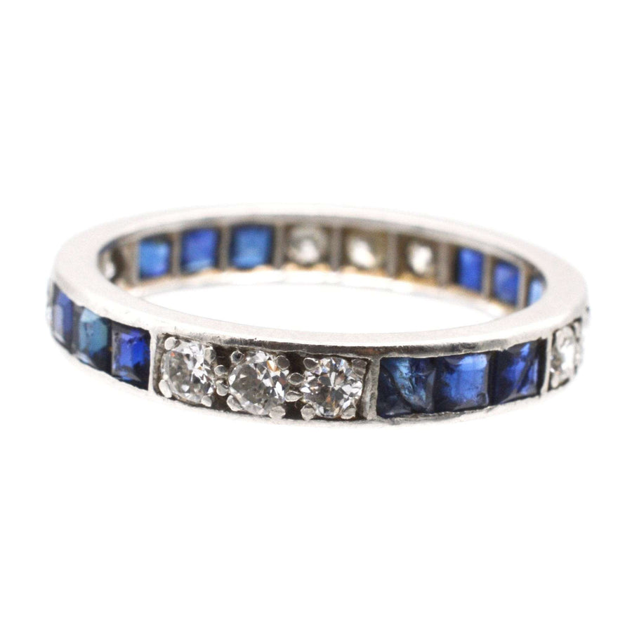 Art Deco 18ct white gold eternity ring featuring sapphires and diamonds, symbolizing everlasting love.