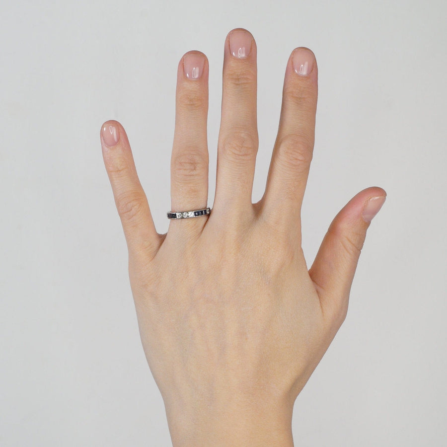 Art Deco 18ct white gold sapphire and diamond eternity ring showcased on a hand.
