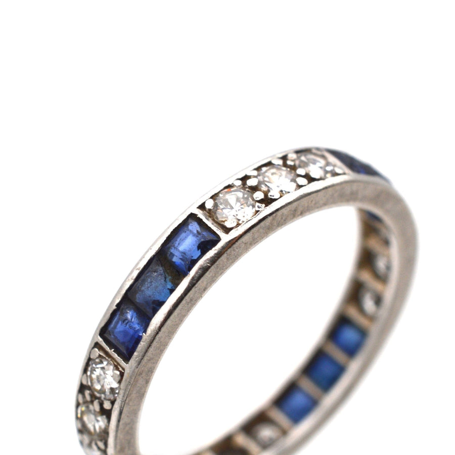 Art Deco 18ct white gold eternity ring featuring blue sapphires and sparkling diamonds.