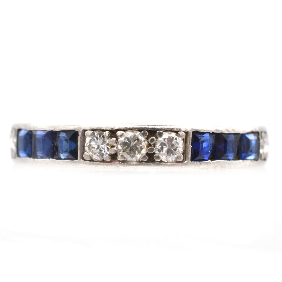 Art Deco white gold eternity ring with sapphires and diamonds, symbolizing love and elegance.