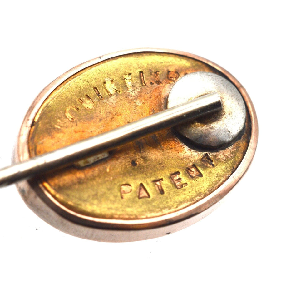 Close-up of the back of a vintage 9ct gold banded sardonyx tie pin with patent details.