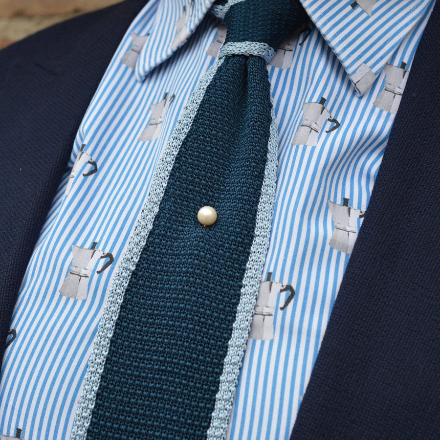 Stylish Art Deco 9ct gold cultured pearl tie pin accentuating a textured tie on a striped shirt.