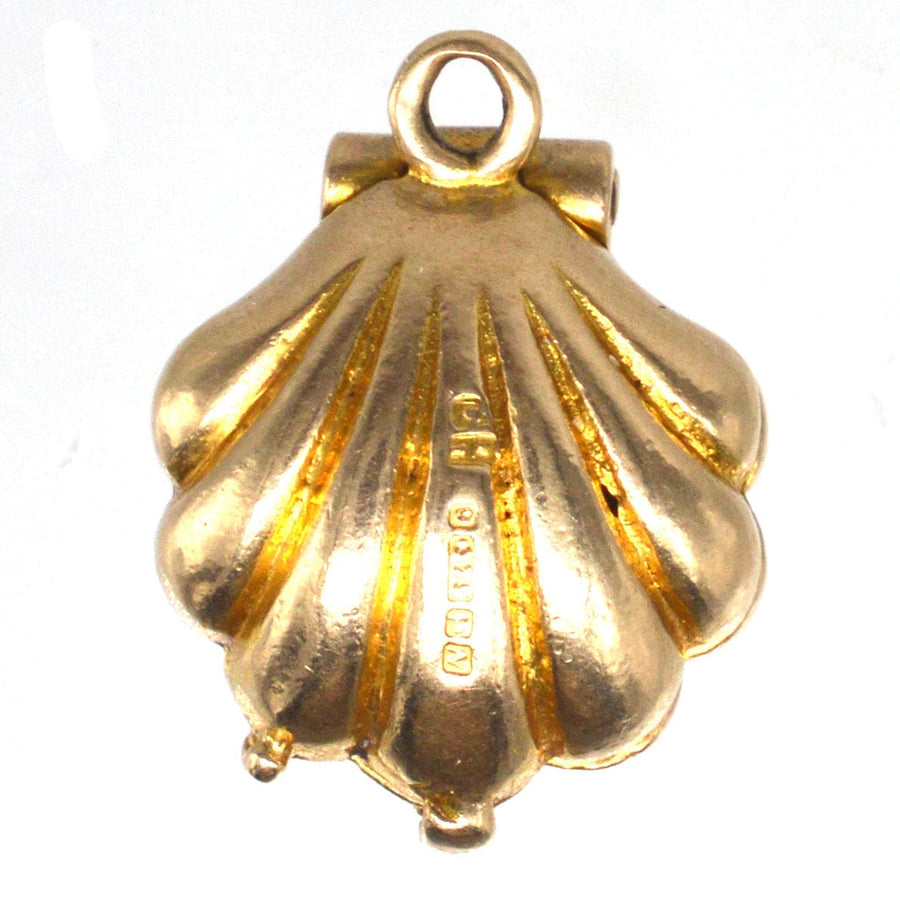 Art Deco 9ct gold scallop shell charm pendant with pearl, crafted in 1937, symbolizing bravery and resilience.