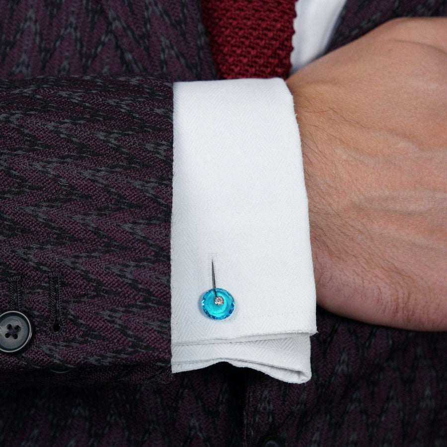 Art Deco blue and white paste cufflink on a white shirt sleeve, illustrating vintage fashion elegance.