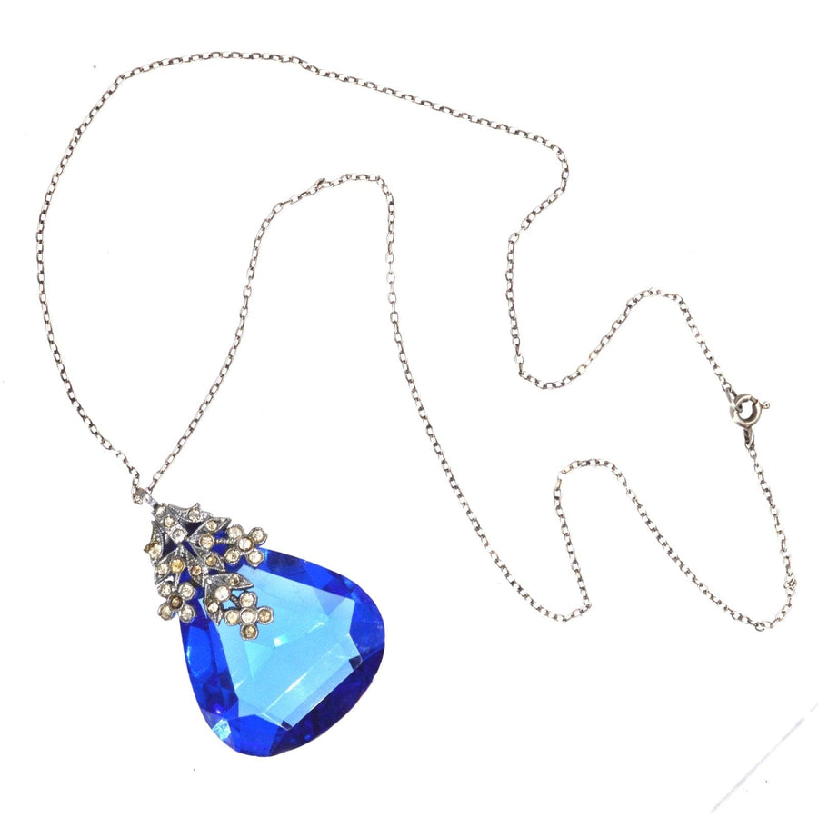 Art Deco blue paste pendant on silver chain with floral white paste setting, showcasing exquisite costume jewellery craftsmanship.