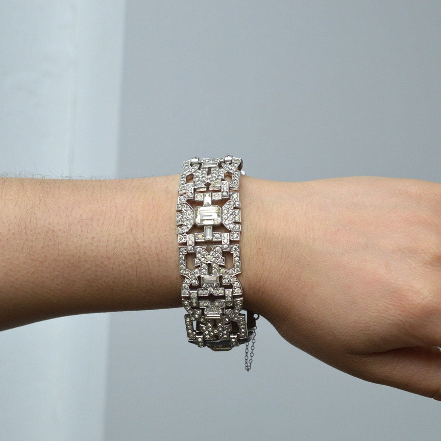 Art Deco chrome 'Diamond' paste bracelet showcased on a hand, featuring bold design and diamond-like sparkle.