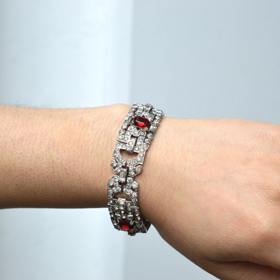 Art Deco chrome bracelet with white stones and red accents, mimicking diamonds and rubies, showcasing elegant costume jewelry.