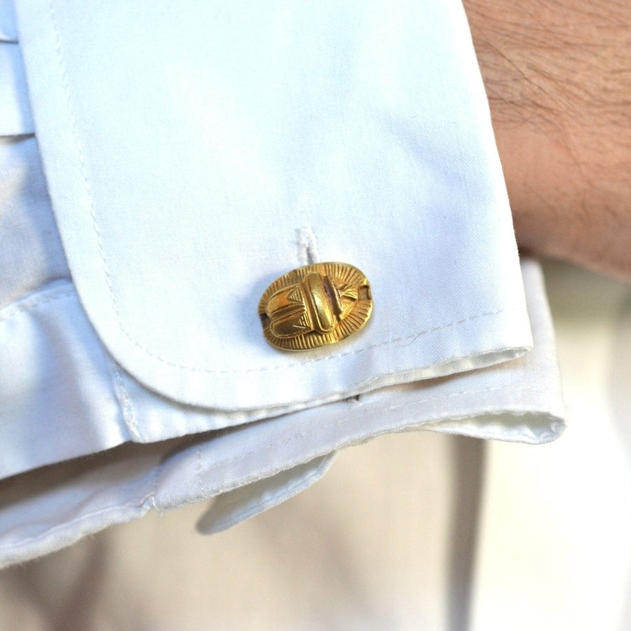 Art Deco Egyptian Revival 18ct gold scarab cufflinks on a white shirt cuff.