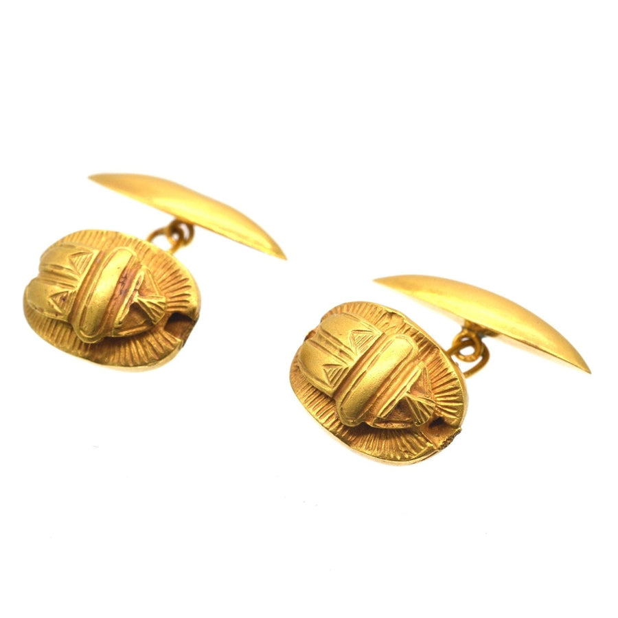 Art Deco Egyptian Revival gold scarab cufflinks showcasing ancient Egyptian motifs and symbolism.
