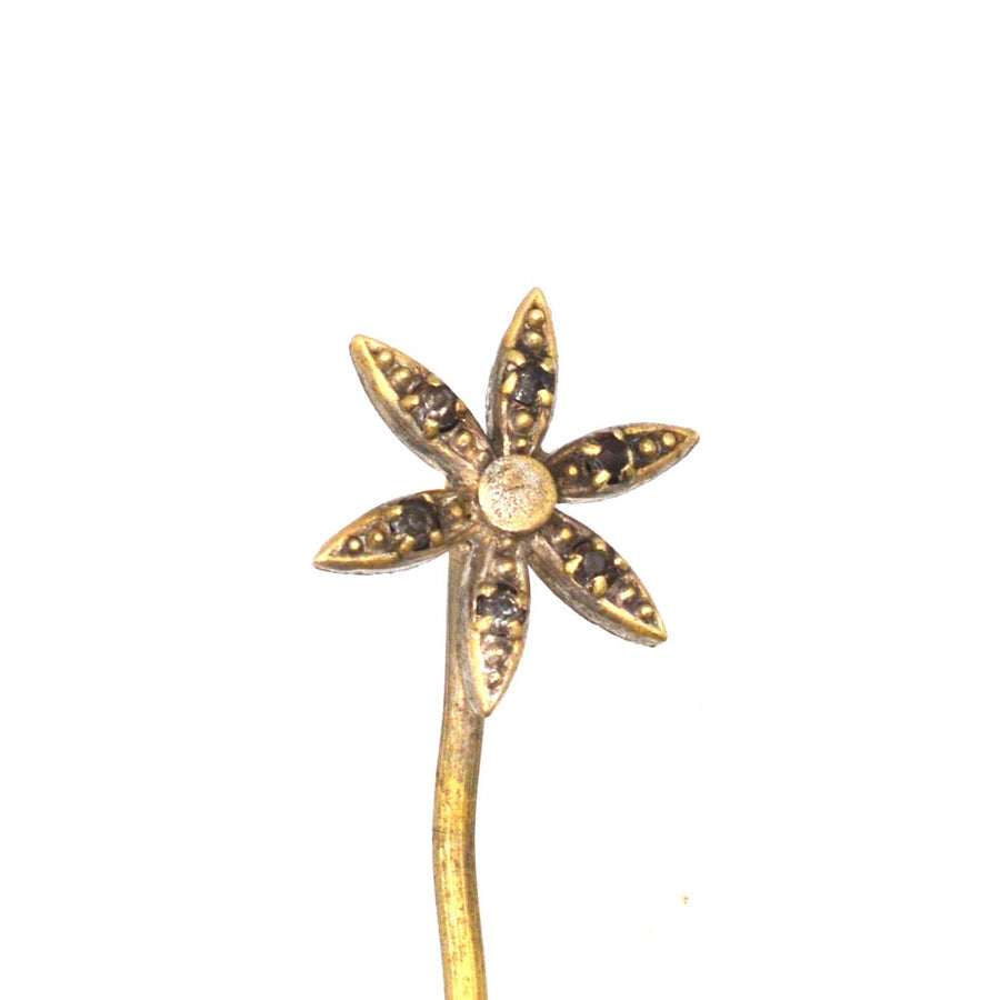 Art Deco flower tie pin featuring glass paste in each petal, perfect for adding elegance to formal wear.