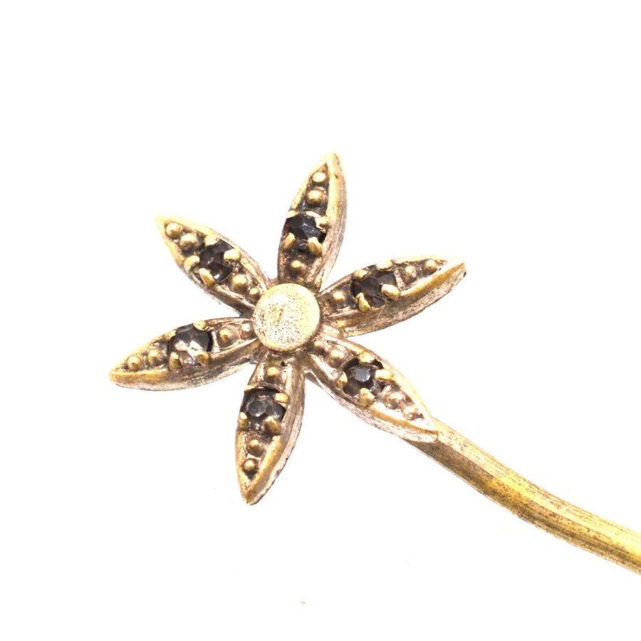 Art Deco flower tie pin with glass paste in petal details, featuring a gold-tone finish and stoppers included.