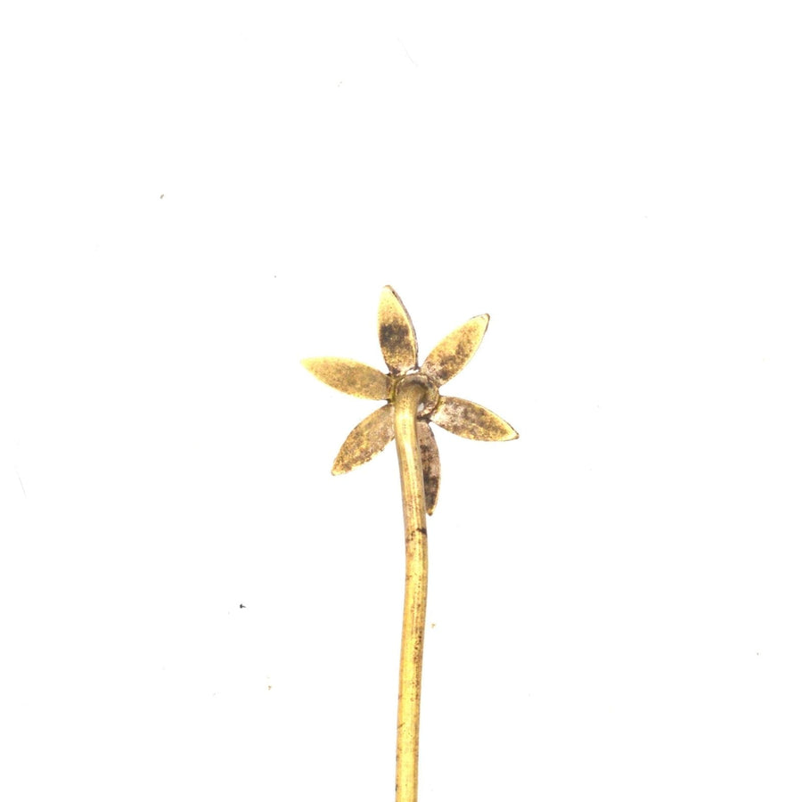 Art Deco flower tie pin with glass details in petals, ideal for formal attire, includes stoppers for secure fastening.