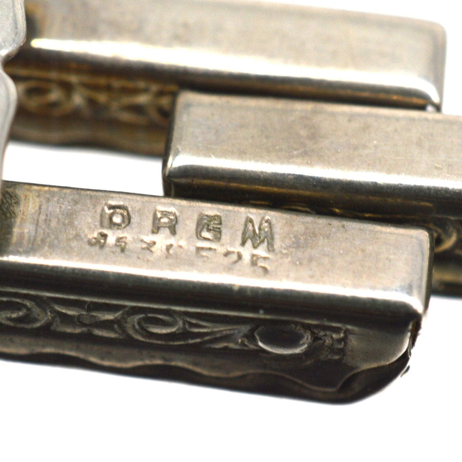 Close-up of a stamped Art Deco German silver tank bracelet with intricate detailing.