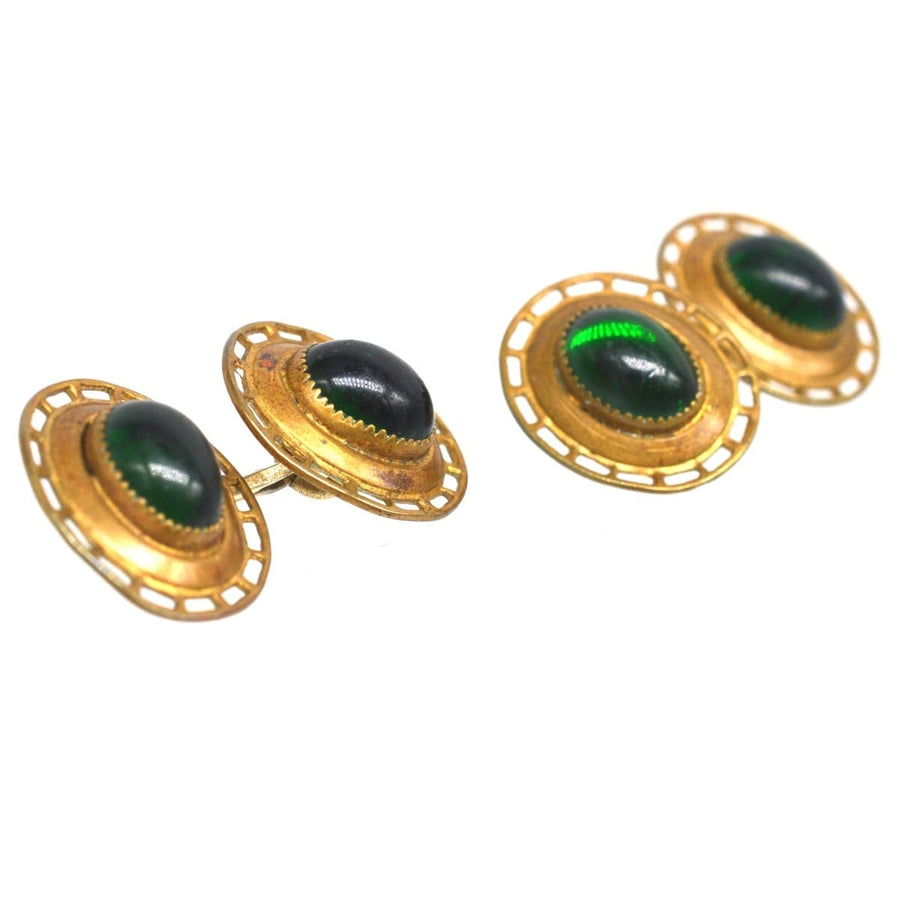Art Deco gilt metal cufflinks featuring green cabochon paste, elegant costume jewelry for a stylish accessory.