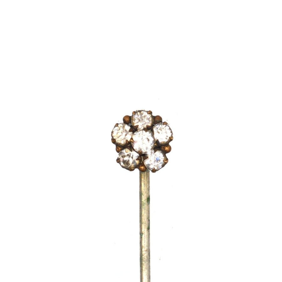 Art Deco gilt metal paste cluster tie pin sparkling on a silk tie, featuring a delightful floral design.