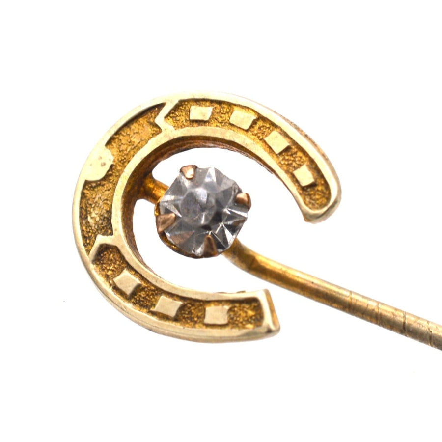 Art Deco horseshoe tie pin with a clear paste stone, symbolizing luck and protection.