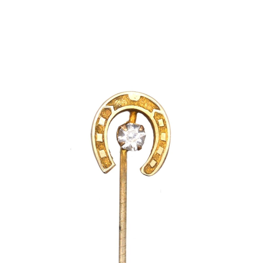 Art Deco horseshoe tie pin featuring a central clear paste, a symbol of luck and protection from harm.