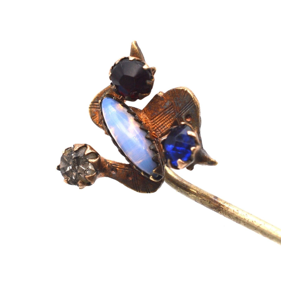 Art Deco Isle of Mann triskelion tie pin with blue, red, white, and opal paste stones intricately designed.