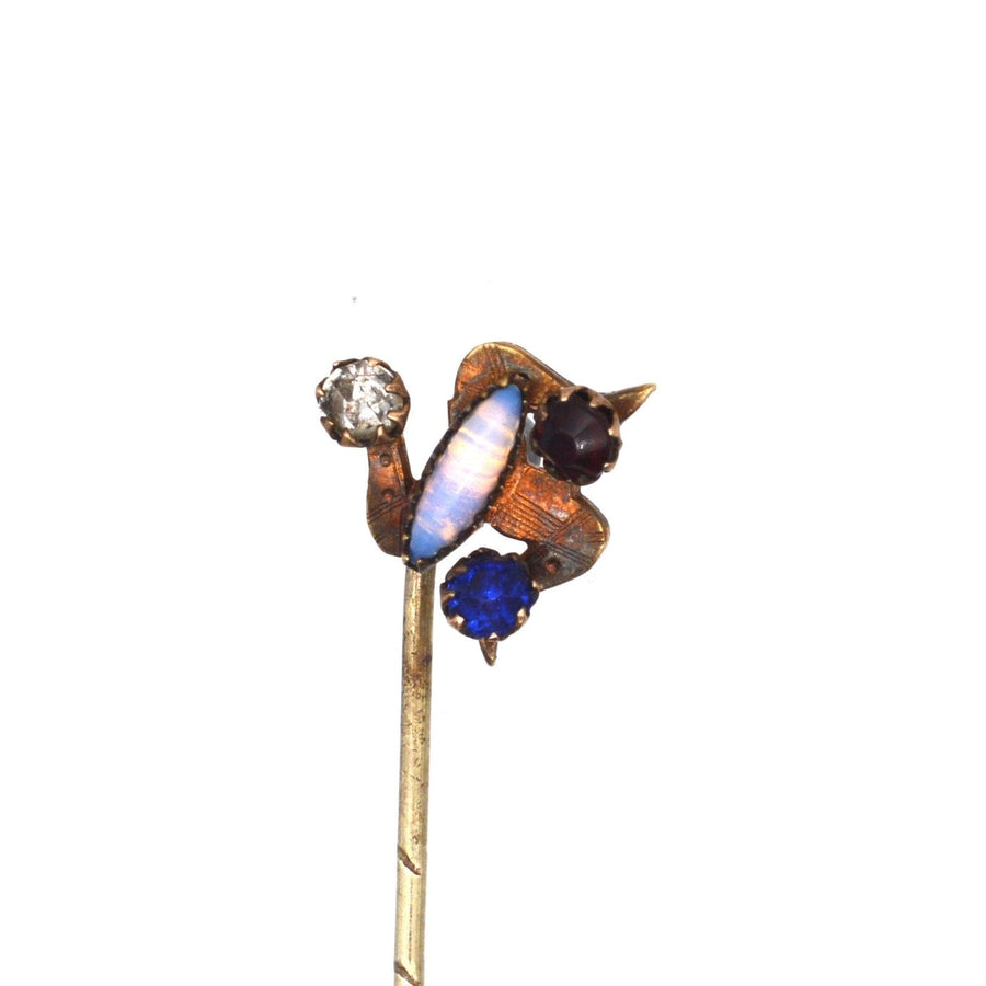 Art Deco Isle of Mann Triskelion tie pin featuring blue, red, white, and opal stones in a unique design.