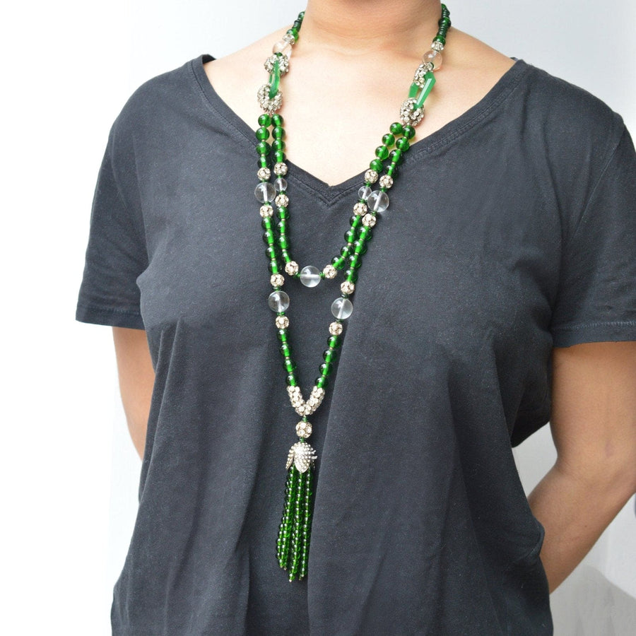 Art Deco long green bead necklace with crystal accents worn on a model, showcasing elegant vintage jewelry style.
