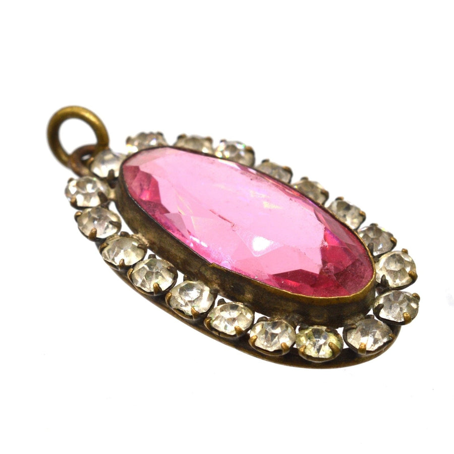 Art Deco pink and white paste cluster oval pendant featuring a pink topaz surrounded by diamond-like stones.