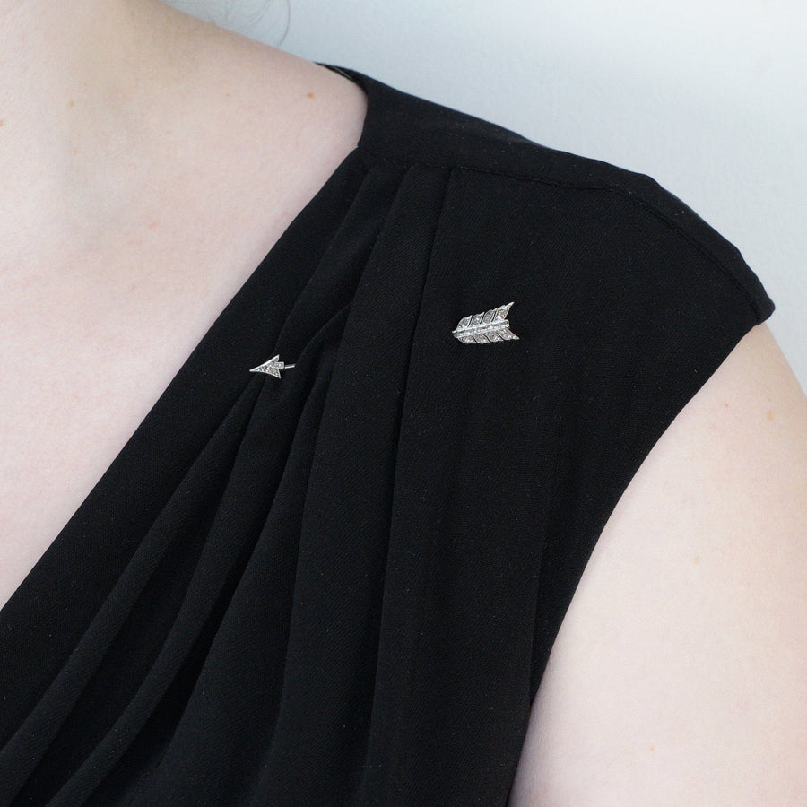 Art Deco platinum and gold rose cut diamond arrow jabot pin brooch worn on black dress shoulder.