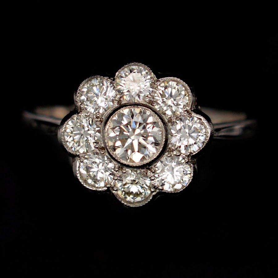Art Deco platinum diamond cluster ring with over a carat of sparkling diamonds in a millegrain setting.