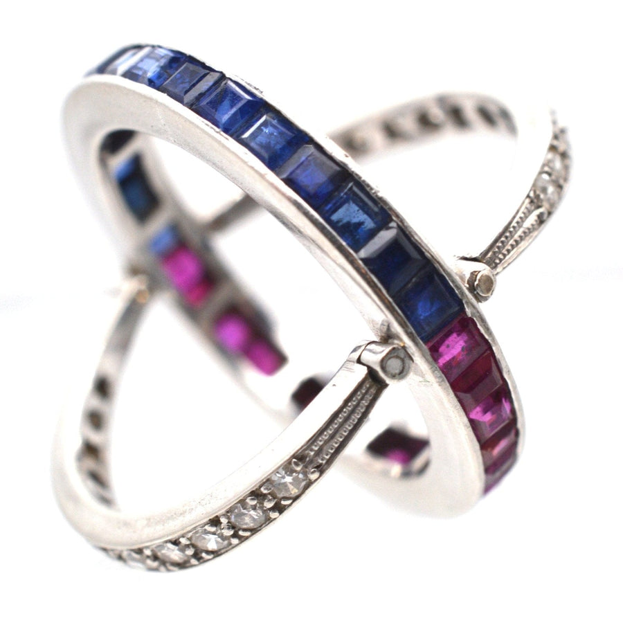 Art Deco platinum flip-over ring featuring diamonds, sapphires, and rubies in a unique versatile design.