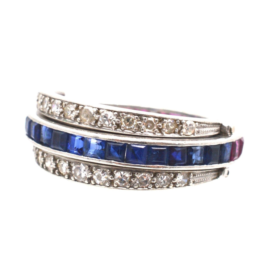 Art Deco platinum ring with sparkling diamonds, sapphire, and ruby flip-over design - versatile jewelry piece.