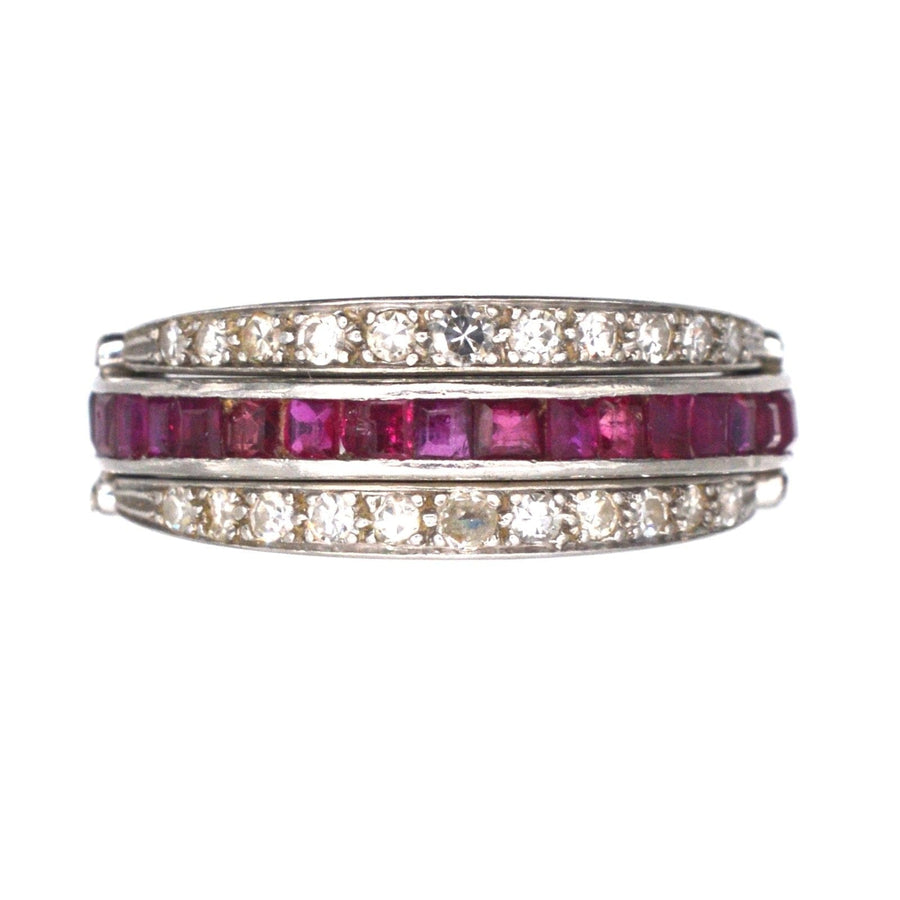 Art Deco platinum ring featuring diamonds, ruby, and sapphire with flip-over design for versatile wear.