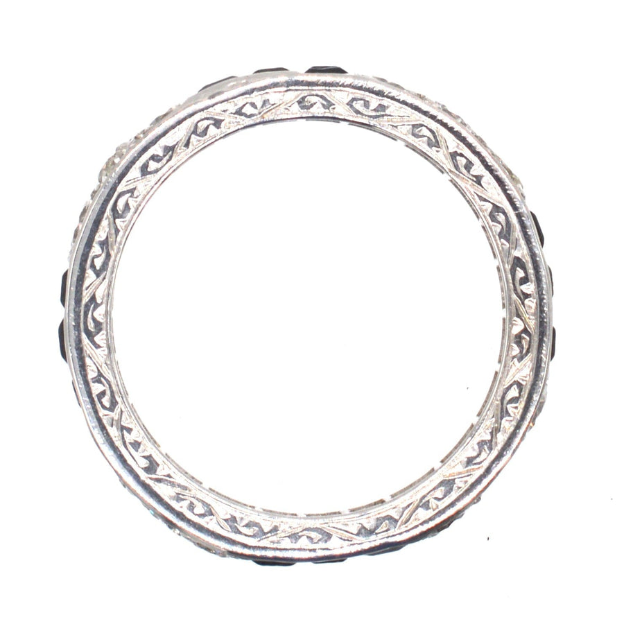 Art Deco platinum eternity ring featuring exquisite sapphire and diamond details, symbolizing everlasting love.