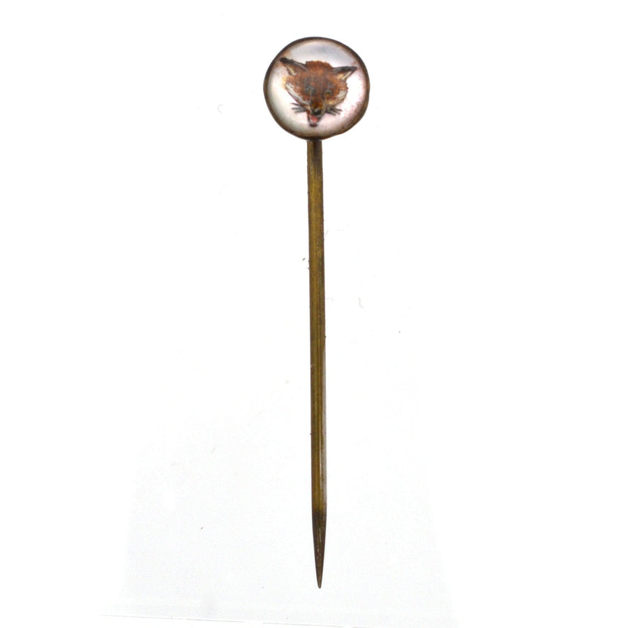 Art Deco tie pin featuring a reverse intaglio of a fox's head on a polished dome, reflecting vintage elegance.