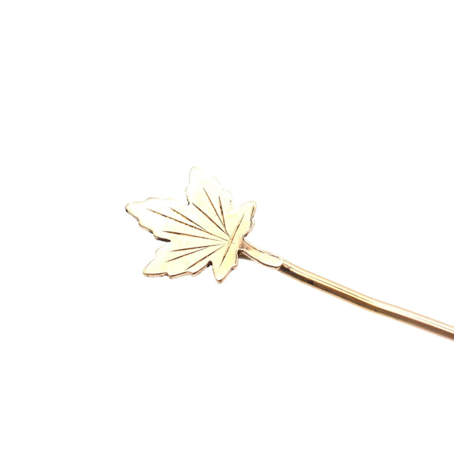 Art Deco rolled gold maple leaf tie pin, symbolizing Canada and Celtic mythology, with intricate details.