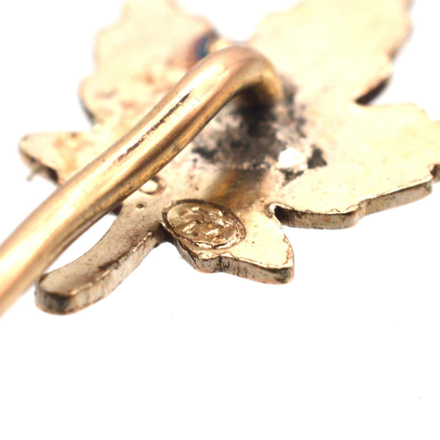 Close-up of an Art Deco rolled gold maple leaf tie pin showcasing detailed leaf design.