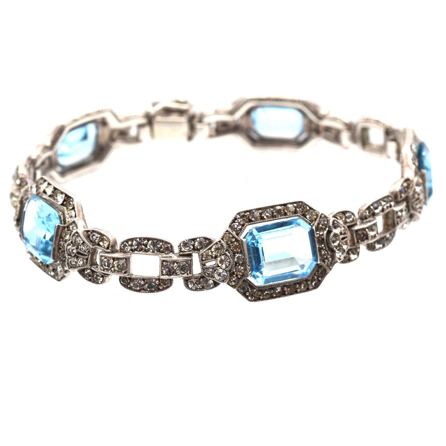 Art Deco silver bracelet featuring aquamarine and diamond-like paste stones, capturing early twentieth century elegance.