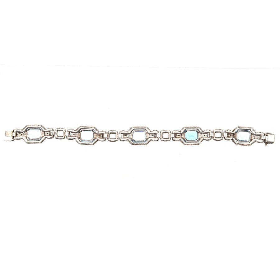 Art Deco silver bracelet featuring blue and white paste stones, reminiscent of aquamarine and diamond jewelry.