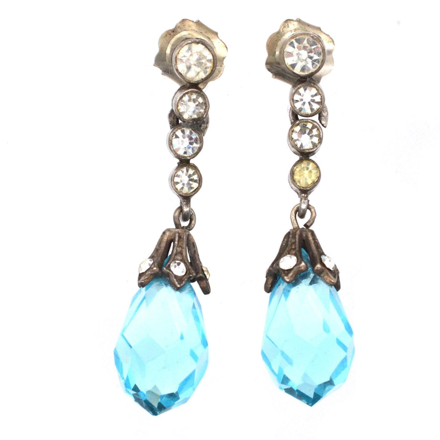 Art Deco silver earrings with blue and white paste gemstones, featuring faceted blue drops and sparkling accents.