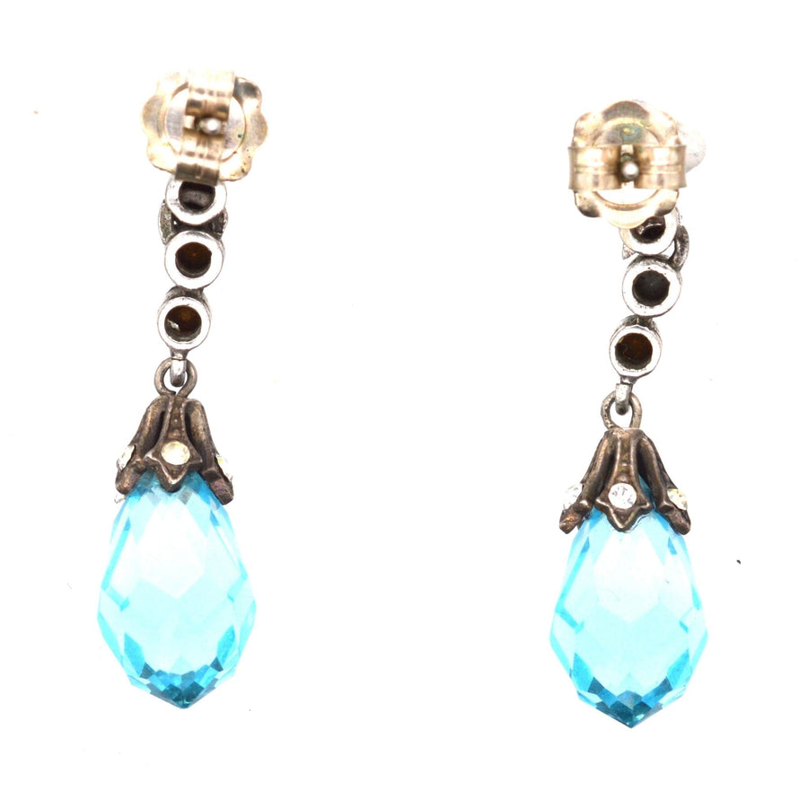 Art Deco silver earrings with blue faceted paste and white accents, perfect for a sophisticated style.