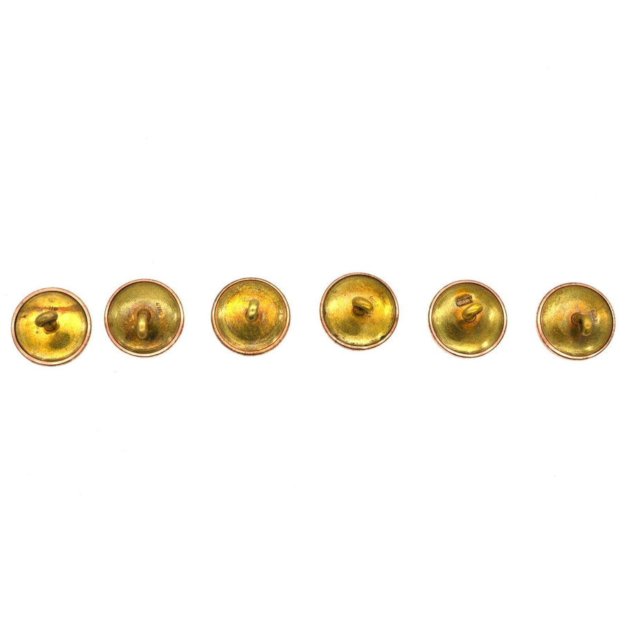 Vintage gold buttons in a row, showcasing their unique design and finish, ideal for dress sets or accessories.