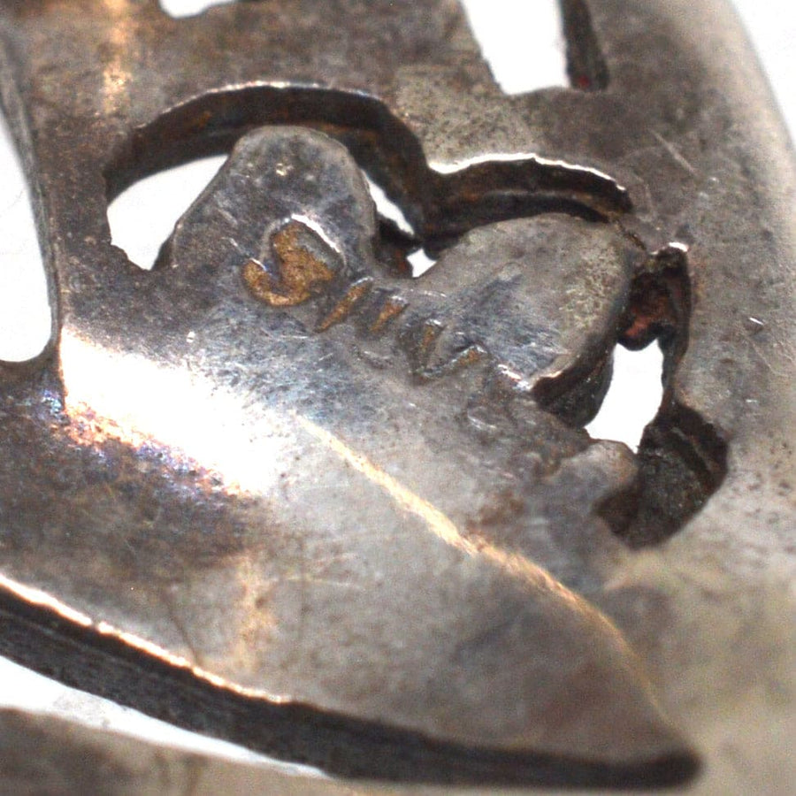 Close-up of silver hallmark on Art Deco silver brooch, showcasing authenticity and craftsmanship.
