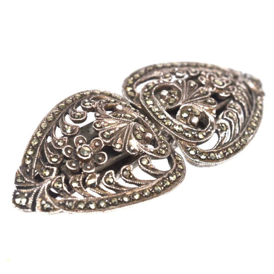Art Deco silver and marcasite double clip brooch from 1927 with intricate floral design and rose cut diamond hues.