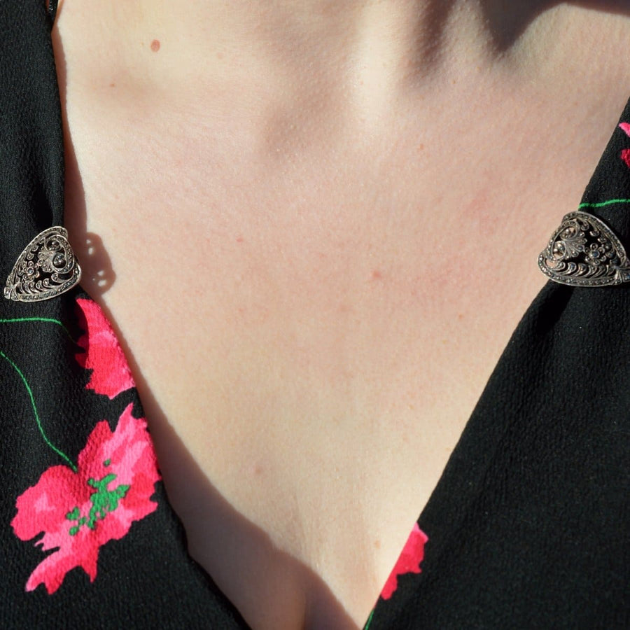 Art Deco silver and marcasite double clip brooch showcased on clothing with vibrant floral design.