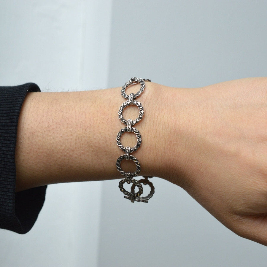 Art Deco silver and marcasite round circle design bracelet worn on wrist, showcasing intricate detailing.