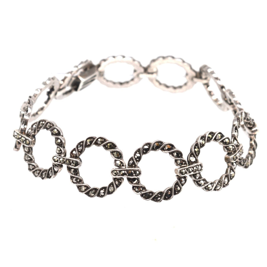 Art Deco silver bracelet with marcasite circlets linked by bars, showcasing vintage 1920s jewelry style.